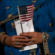 An immigrant holds an American flag as she is sworn in as a U.S. citizen during a naturalization ceremony at the Paramount Theatre on Nov. 18, 2015, in Oakland, Calif.
Justin Sullivan/Getty Images